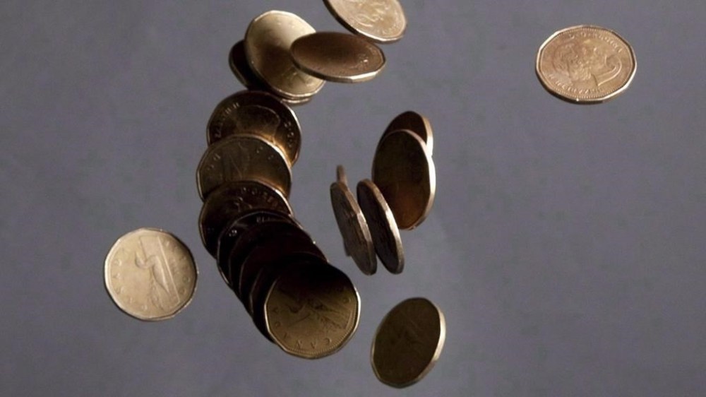Falling Canadian loonies are pictured in Vancouver on September 22, 2011. Canada's housing agency says the country has the highest level of household debt in the G7, making its economy vulnerable to a global economic crisis. THE CANADIAN PRESS/Jonathan Hayward