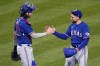 Texas Rangers starting pitcher Nathan Eovaldi, right, celebrates the team's 6-1 win over the Pittsburgh Pirates with catcher Jonah Heim, after a baseball game in Pittsburgh, Tuesday, May 23, 2023. (AP Photo/Gene J. Puskar)