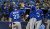 Toronto Blue Jays' Daulton Varsho (25) and Kevin Kiermaier, right, congratulate Danny Jansen, who had hit a two-run home run off Tampa Bay Rays Christian Bethancourt during the ninth inning of a baseball game Tuesday, May 23, 2023, in St. Petersburg, Fla. (AP Photo/Steve Nesius)