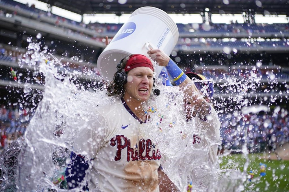 Philadelphia Phillies' Alec Bohm is dunked after he hit a game-winning RBI-single against Arizona Diamondbacks relief pitcher Jose Ruiz during the tenth inning of a baseball game, Wednesday, May 24, 2023, in Philadelphia. (AP Photo/Matt Slocum)