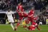 Real Madrid's Rodrygo, left, shoots besides Rayo's Alejandro Catena during a Spanish La Liga soccer match between Real Madrid and Rayo Vallecano at the Santiago Bernabeu stadium in Madrid, Spain, Wednesday, May 24, 2023. (AP Photo/Manu Fernandez)
