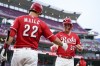 Cincinnati Reds' Tyler Stephenson (37) celebrates with Luke Maile (22) after scoring on a double hit by Stuart Fairchild in the sixth inning of a baseball game in Cincinnati, Wednesday, May 24, 2023. (AP Photo/Jeff Dean)