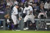 Miami Marlins third base coach Jody Reed, left, congratulates Jonathan Davis for a solo home run off Colorado Rockies relief pitcher Peter Lambert during the sixth inning of a baseball game Wednesday, May 24, 2023, in Denver. (AP Photo/David Zalubowski)