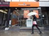 A woman walks past a Freedom Mobile story in Toronto on November 24, 2016. THE CANADIAN PRESS/Nathan Denette