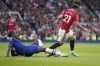 Chelsea's Trevoh Chalobah, left, challenges for the ball with Manchester United's Antony during the English Premier League soccer match between Manchester United and Chelsea at the Old Trafford stadium in Manchester, England, Thursday, May 25, 2023. (AP Photo/Dave Thompson)