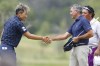 Katsumasa Miyamoto, left, of Japan, shakes hands with Todd Sapere, center, of the United States, and Mauricio Molina, of Argentina, after finishing the first round of the KitchenAid Senior PGA Championship golf tournament at Fields Ranch East golf course at PGA of America in Frisco, Texas, Thursday, May 25, 2023.(Elías Valverde II/The Dallas Morning News via AP)