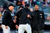 Home plate umpire Edwin Moscoso, right, talks to New York Yankees manager Aaron Boone as Boone is restrained after being ejected during the third inning of the team's baseball game against the Baltimore Orioles on Thursday, May 25, 2023, in New York. (AP Photo/Frank Franklin II)