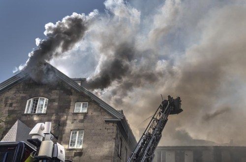 Firefighters respond to a five-alarm fire at the former Monastere du Bon Pasteur, a 19th century heritage building on Friday May 26, 2023 in Montreal. THE CANADIAN PRESS/Christinne Muschi