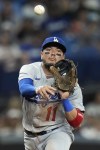 Los Angeles Dodgers shortstop Miguel Rojas (11) throws out Tampa Bay Rays' Jose Siri at first base during the fourth inning of a baseball game Friday, May 26, 2023, in St. Petersburg, Fla. (AP Photo/Chris O'Meara)