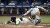 Los Angeles Dodgers catcher Will Smith, right, tags out Tampa Bay Rays' Yandy Diaz at home plate after he tried to score on a single by Wander Franco during the eighth inning of a baseball game Friday, May 26, 2023, in St. Petersburg, Fla. (AP Photo/Chris O'Meara)