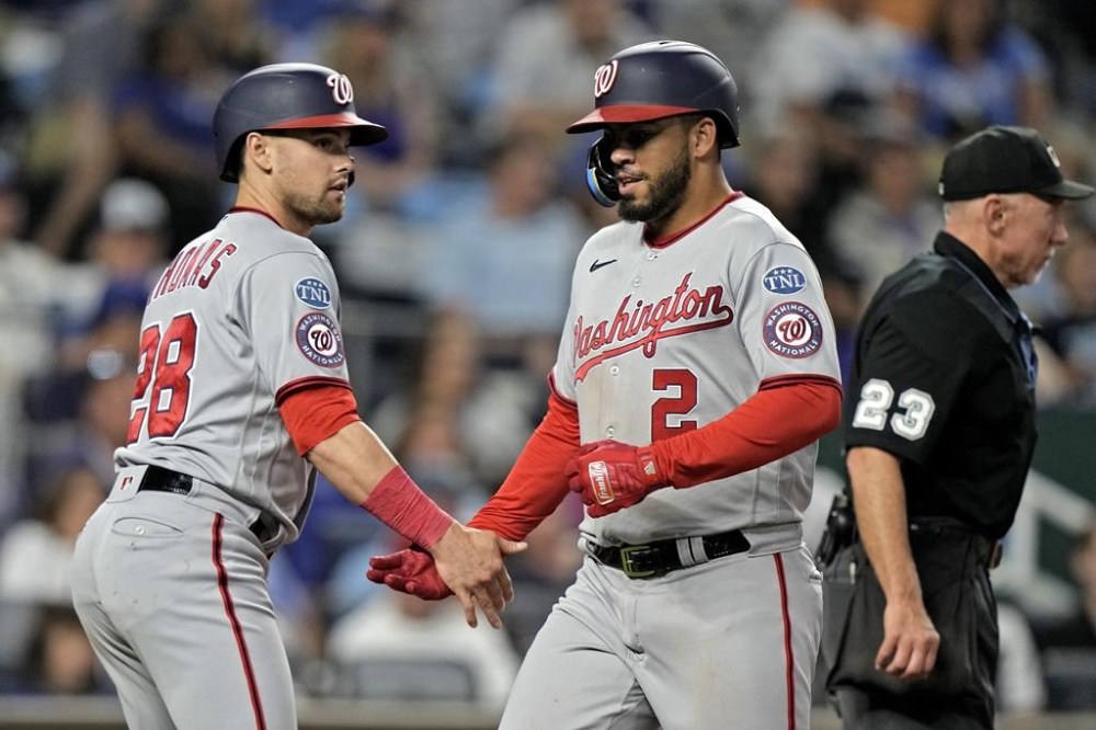 Washington Nationals' Luis Garcia (2) celebrates with Lane Thomas (28) after they scored on a single hit by Joey Meneses during the sixth inning of a baseball game against the Kansas City Royals Friday, May 26, 2023, in Kansas City, Mo. (AP Photo/Charlie Riedel)