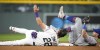 New York Mets second baseman Jeff McNeil, right, tumbles after tagging out Colorado Rockies' Nolan Jones, left, at second base as Jones tried to advance on a ground ball in the ninth inning of a baseball game Friday, May 26, 2023, in Denver. (AP Photo/David Zalubowski)