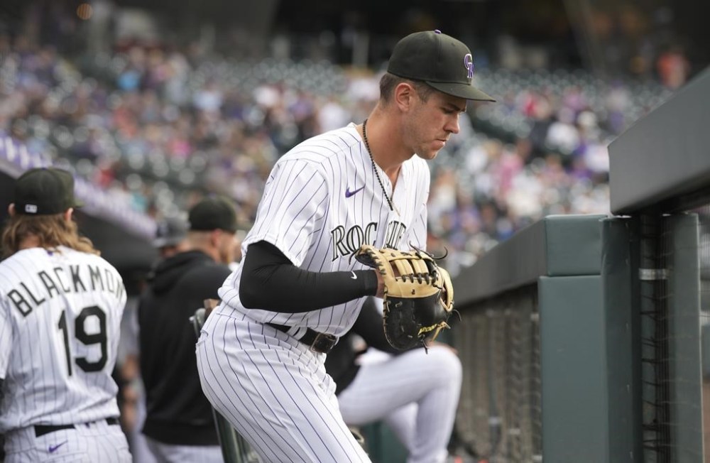 Colorado Rockies first baseman Nolan Jones heads out of the dugout for the first inning of a baseball game against the New York Mets, Friday, May 26, 2023, in Denver. (AP Photo/David Zalubowski)