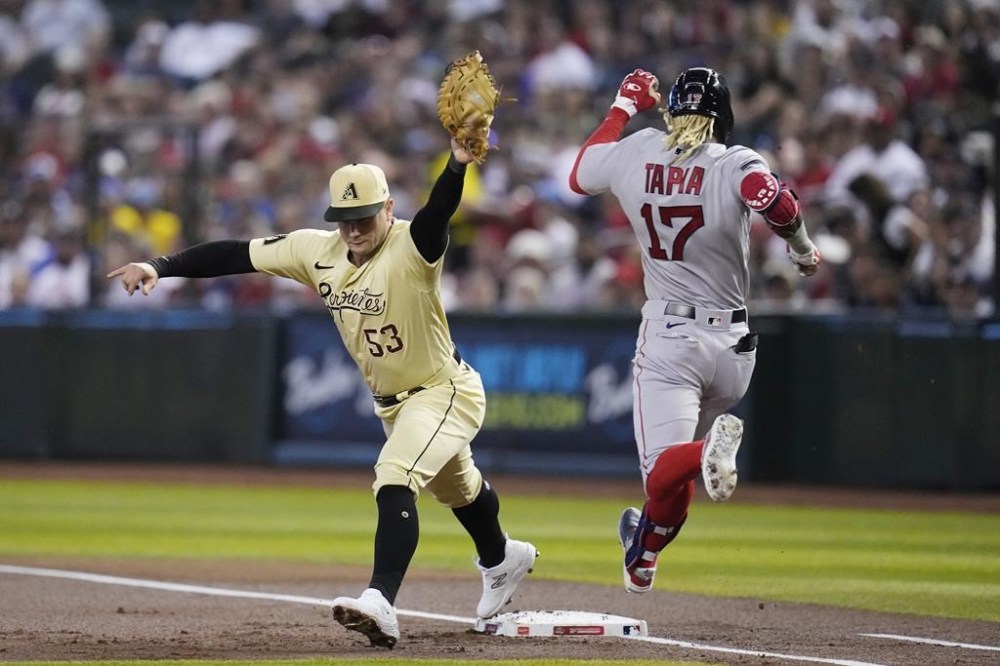 Arizona Diamondbacks first baseman Christian Walker (53) makes a catch for the out at first base against Boston Red Sox's Raimel Tapia (17) during the first inning of a baseball game Friday, May 26, 2023, in Phoenix. (AP Photo/Ross D. Franklin)