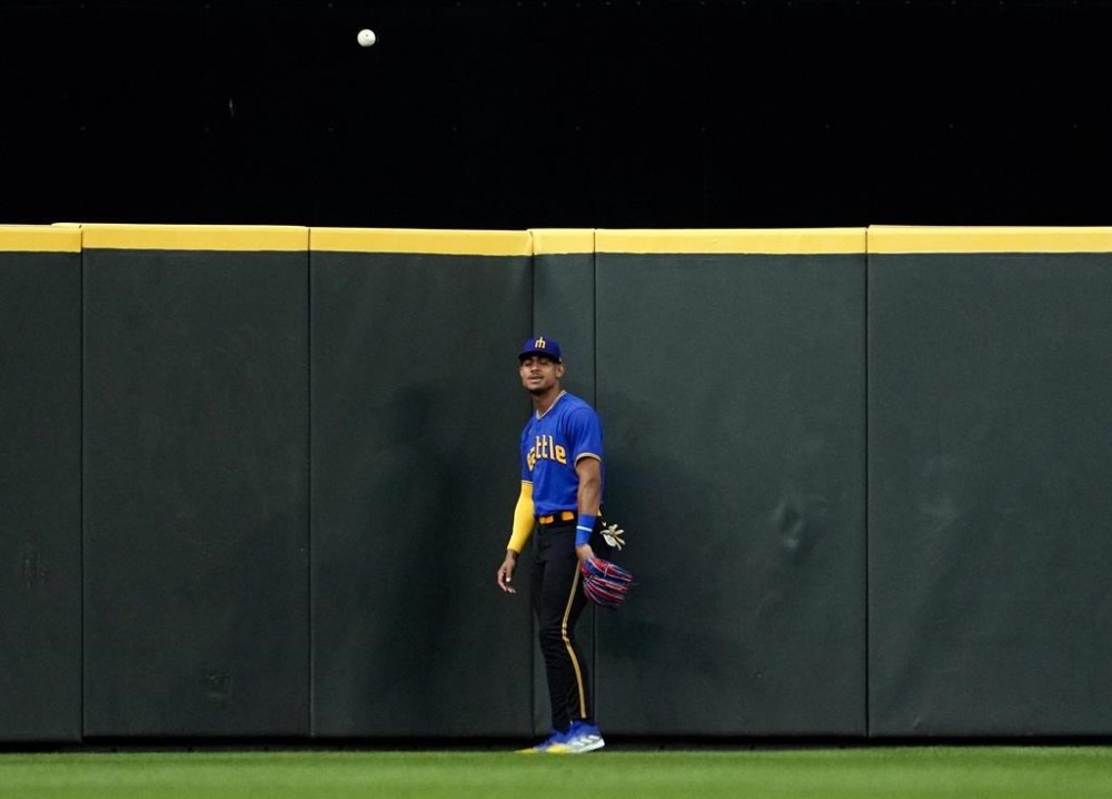 Seattle Mariners center fielder Julio Rodriguez watches as the ball from a two-run home run by Pittsburgh Pirates' Jack Suwinski bounces back up from center field during the fifth inning of a baseball game Friday, May 26, 2023, in Seattle. (AP Photo/Lindsey Wasson)