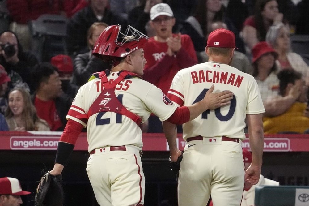 Los Angeles Angels relief pitcher Sam Bachman, right, gets a pat on the back from catcher Matt Thaiss after the eighth inning of a baseball game against the Miami Marlins Friday, May 26, 2023, in Anaheim, Calif. (AP Photo/Mark J. Terrill)