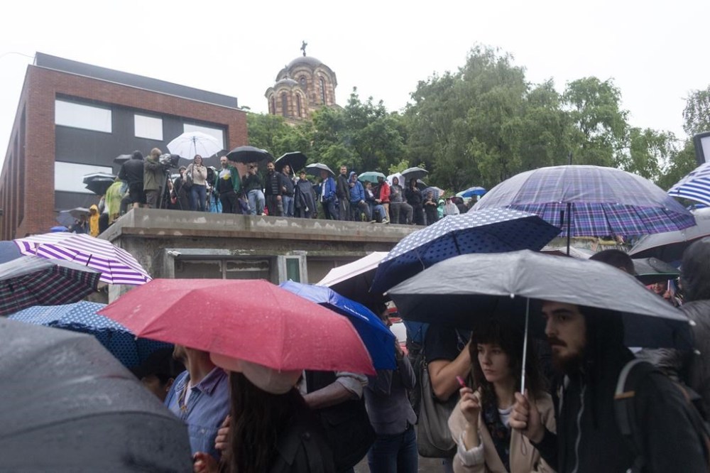 People attend a protest in front of the state-run TV headquarters in Belgrade, Serbia, Saturday, May 27, 2023. The protests in Belgrade and other Serbian cities are the biggest in years against Serbian president Aleksandar Vucic and his government. They were organized in response to a pair of mass shootings earlier this month that left 18 people dead and 20 wounded, many of them children from an elementary school. (AP Photo/Marko Drobnjakovic)
