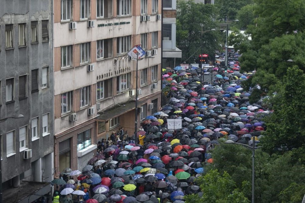 People pack a street in front of the state-run TV headquarters during an opposition-led protest in Belgrade, Serbia, Saturday, May 27, 2023. The protests in Belgrade and other Serbian cities are the biggest in years against Serbian president Aleksandar Vucic and his government. They were organized in response to a pair of mass shootings earlier this month that left 18 people dead and 20 wounded, many of them children from an elementary school. (AP Photo/Marko Drobnjakovic)