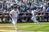 New York Yankees Isiah Kiner-Falefa, left, runs to first base on a single that scores teammate Greg Allen, right, for a tenth inning win in a baseball game against the San Diego Padres, Saturday, May 27, 2023, in New York. (AP Photo/Bebeto Matthews)