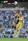 Minnesota United midfielder Hassani Dotson (31) heads the ball over Real Salt Lake defender Jasper Löffelsend (28) in the first half of an MLS soccer match, Saturday, May 27, 2023, at Allianz Field in St. Paul, Minn. (Alex Kormann/Star Tribune via AP)