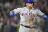 New York Mets' Francisco Alvarez reacts after hitting a three-run home run off Colorado Rockies relief pitcher Jake Bird in the sixth inning of a baseball game Saturday, May 27, 2023, in Denver. (AP Photo/David Zalubowski)
