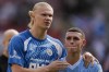 Manchester City's Erling Haaland, left, hugs Manchester City's Phil Foden at the end of the English Premier League soccer match between Brentford and Manchester City at the Gtech Community Stadium in London, Sunday, May 28, 2023. (AP Photo/Kirsty Wigglesworth)