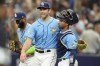 Tampa Bay Rays relief pitcher Jason Adam, center, celebrates with catcher Francisco Mejia, right, and first baseman Yandy Diaz after closing out the Los Angeles Dodgers during the ninth inning of a baseball game Sunday, May 28, 2023, in St. Petersburg, Fla. (AP Photo/Chris O'Meara)