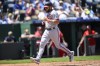 Washington Nationals' Dominic Smith scores on a double by Washington Nationals' Ildemaro Vargas during the fourth inning of a baseball game, Sunday, May 28, 2023, in Kansas City, Mo. (AP Photo/Reed Hoffmann)