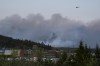 A helicopter carrying water flies over heavy smoke from an out-of-control fire in a suburban community outside of Halifax that spread quickly, engulfing multiple homes and forcing the evacuation of local residents on Sunday May 28, 2023.THE CANADIAN PRESS/Darren Calabrese
