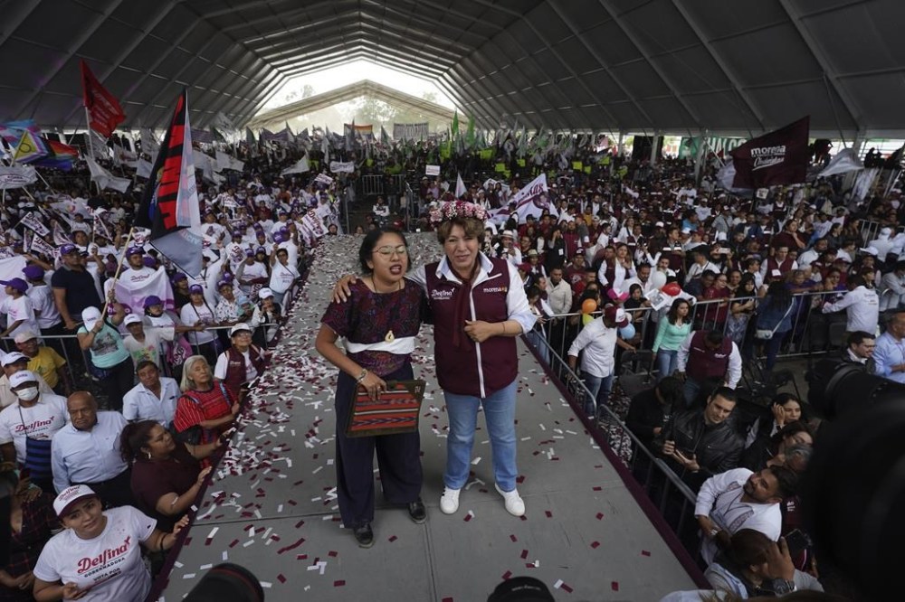Delfina Gomez, center right, MORENA political party gubernatorial candidate, greets supporters as she campaigns in Valle de Chalco, Mexico, Sunday, May 28, 2023. Voters in the state of Mexico go to the polls on June 4 to elect a new governor. (AP Photo/Marco Ugarte)