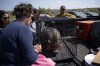Members of the Department of Natural Resources and volunteers from a pet service care for a pig named Peppa that they rescued from the evacuated zone of the wildfire burning in Tantallon, N.S., outside of Halifax on Monday, May 29, 2023. THE CANADIAN PRESS/Darren Calabrese