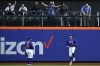 Fans react after New York Mets' Brandon Nimmo (9) caught a ball hit by Philadelphia Phillies' Nick Castellanos for the out during the fourth of a baseball game Tuesday, May 30, 2023, in New York. (AP Photo/Frank Franklin II)