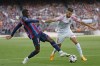 Barcelona's Ousmane Dembele, left, challenges for the ball with Mallorca's Jose Manuel Copete during a Spanish La Liga soccer match between Barcelona and Mallorca at the Camp Nou stadium in Barcelona, Spain, Sunday, May 28, 2023. (AP Photo/Joan Monfort)