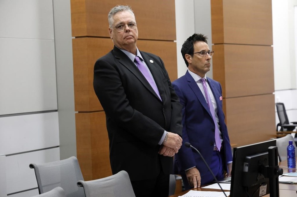 Former Marjory Stoneman Douglas High School School Resource Officer Scot Peterson, standing with his defense attorney Mark Eiglarsh, looks towards the courtroom gallery as prospective jurors enter at the Broward County Courthouse in Fort Lauderdale on Wednesday, May 31, 2023. Jury selection began in the trial of the former Florida sheriff's deputy charged with failing to confront the shooter who killed 14 students and three staff members at a Parkland high school five years ago. (Amy Beth Bennett/South Florida Sun-Sentinel via AP, Pool)