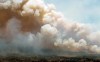 An aircraft (centre) disperses a mix of water and fire retardant over a fire near Barrington Lake in Shelburne County, N.S. in this Wednesday, May 31, 2023 handout photo. More than 300 firefighters from the United States and South Africa are heading to Canada in the coming days as the country battles an unprecedented wildfire season. THE CANADIAN PRESS/HO-Communications Nova Scotia **MANDATORY CREDIT**