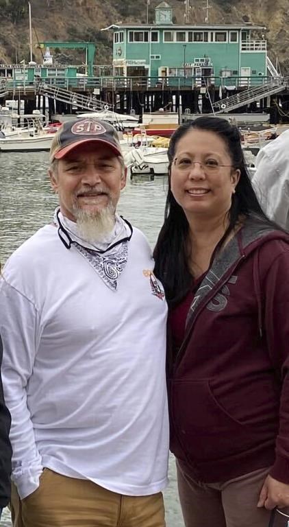 CAPTION CORRECTION: CORRECTS RAN INTO TROUBLE, NOT SCUTTLED: This undated photo provided by James Solis shows Robert Solis, left and his partner Brandi Tyau, right. Robert Solis and Tyau were aboard the charter fishing vessel Awakin when it ran into trouble Sunday in rough seas off the coast of southeast Alaska. The bodies of three of the five people aboard have been found but two people remain missing. Authorities are working to salvage the boat, which was found partially submerged off an island near Sitka, Alaska. Those on the vessel were Solis and Tyau, Tyau's sister and her partner and the boat captain. (James Solis via AP)