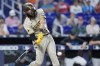 San Diego Padres' Fernando Tatis Jr. hits a ground rule double scoring Ha-Seong Kim, during the fourth inning of a baseball game against the Miami Marlins, Thursday, June 1, 2023, in Miami. (AP Photo/Wilfredo Lee)