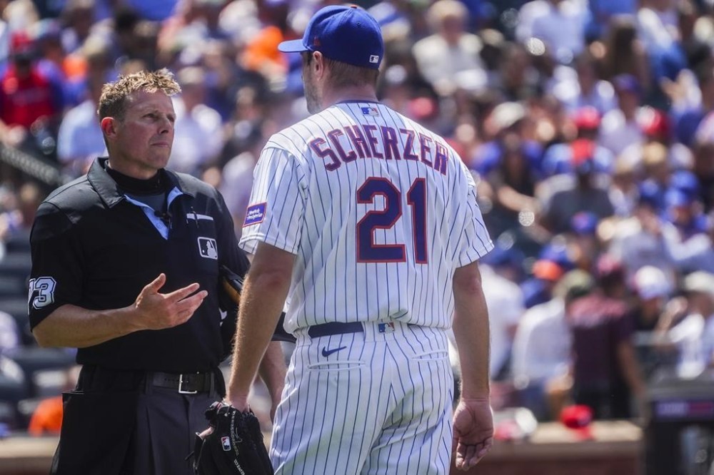 New York Mets starting pitcher Max Scherzer speaks with home plate umpire Tripp Gibson before the fifth inning of a baseball game against Philadelphia Phillies, Thursday, June 1, 2023, in New York. (AP Photo/Bebeto Matthews)