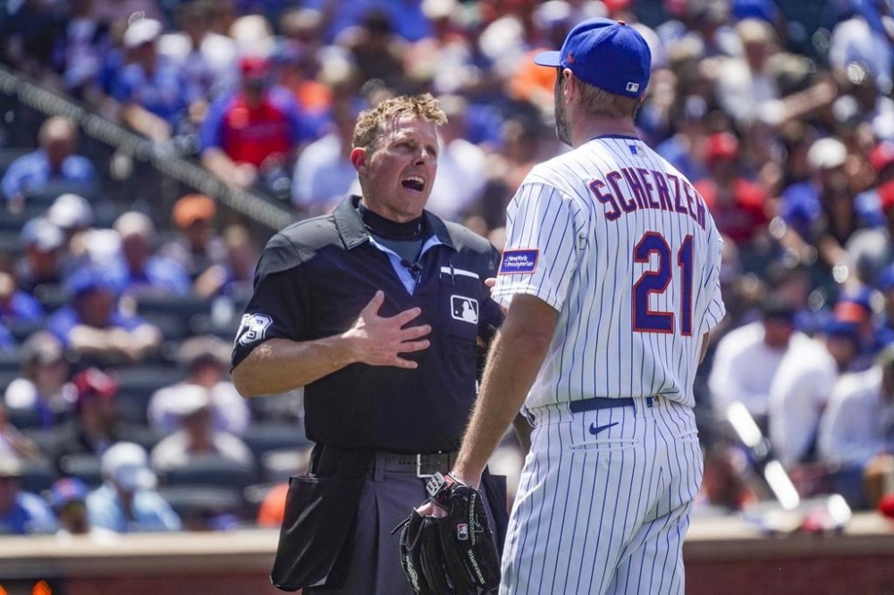 New York Mets starting pitcher Max Scherzer speaks with home plate umpire Tripp Gibson before the fifth inning of a baseball game against Philadelphia Phillies, Thursday, June 1, 2023, in New York. (AP Photo/Bebeto Matthews)