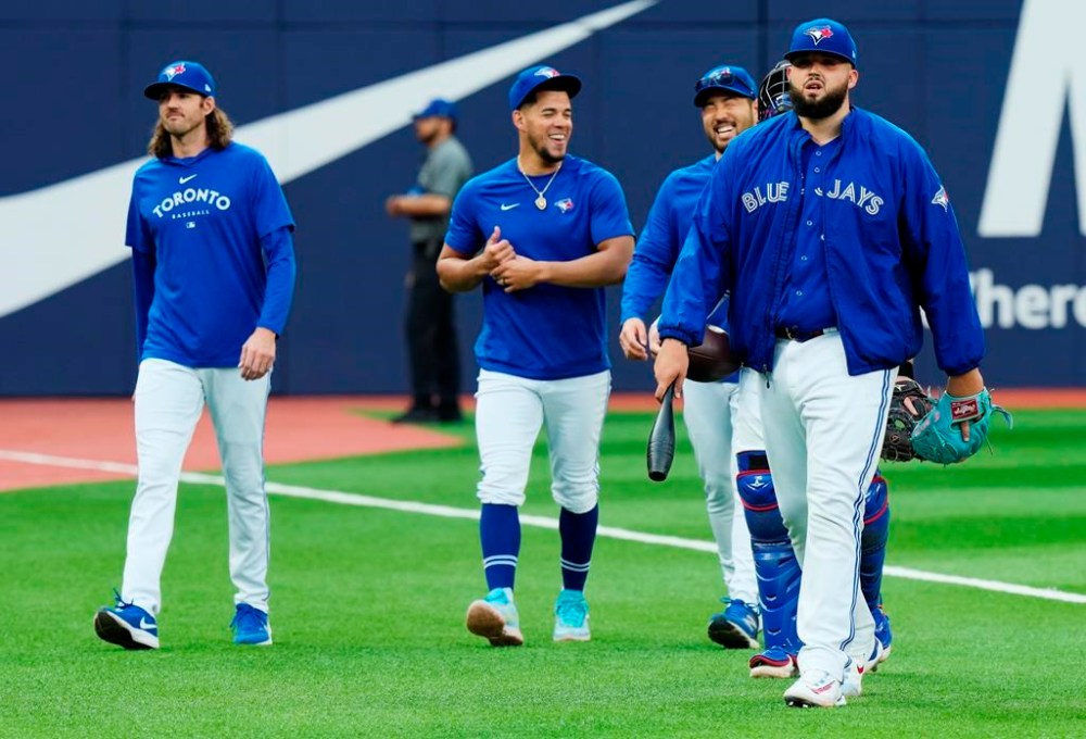 Toronto Blue Jays starting pitcher Alek Manoah, right, walks to the dugout with his fellow starting pitchers Kevin Gausman, left to right, Jose Berrios and Yusei Kikuchi prior to MLB baseball action against the Milwaukee Brewers in Toronto on Wednesday, May 31, 2023.THE CANADIAN PRESS/Frank Gunn