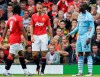 FILE - Manchester City's Mario Balotelli, right, celebrates after scoring against Manchester United during their English Premier League soccer match at Old Trafford Stadium, on Oct. 23, 2011, in Manchester, England. Manchester City and Manchester United meet in the FA Cup final on Saturday. It’s the latest chapter of an intense local rivalry that has included some memorable games. (AP Photo/Jon Super, file)