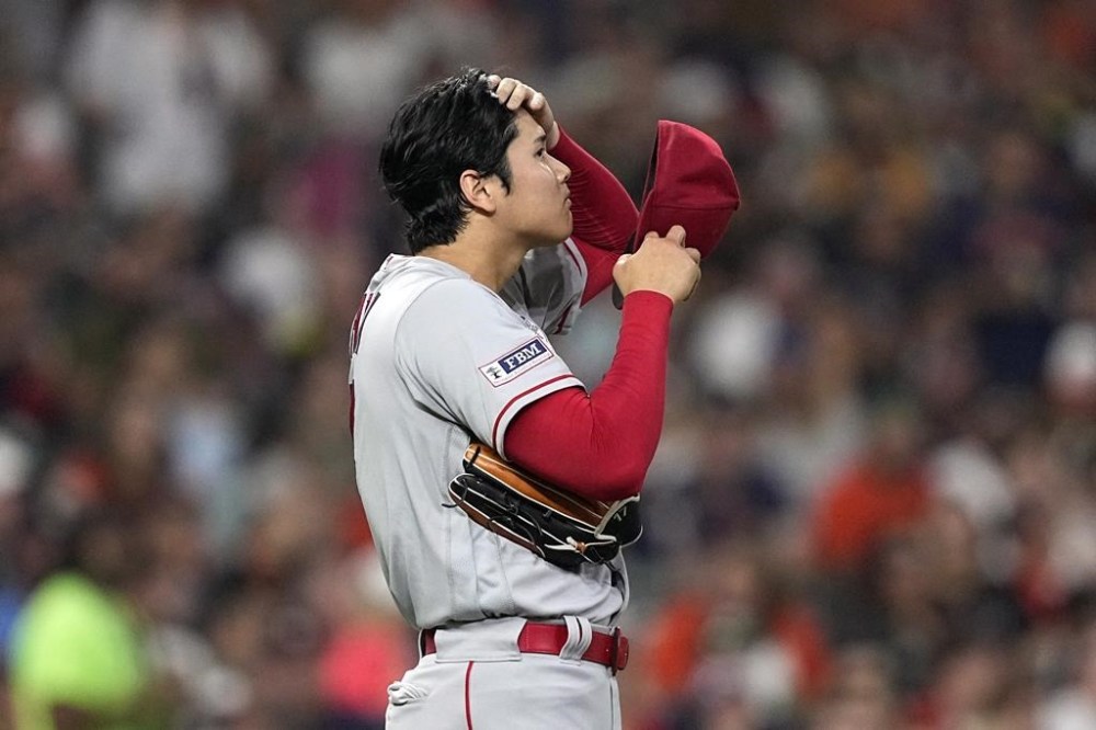 Los Angeles Angels starting pitcher Shohei Ohtani wipes is head after giving up a hit during the fourth inning of a baseball game against the Houston Astros Friday, June 2, 2023, in Houston. (AP Photo/David J. Phillip)