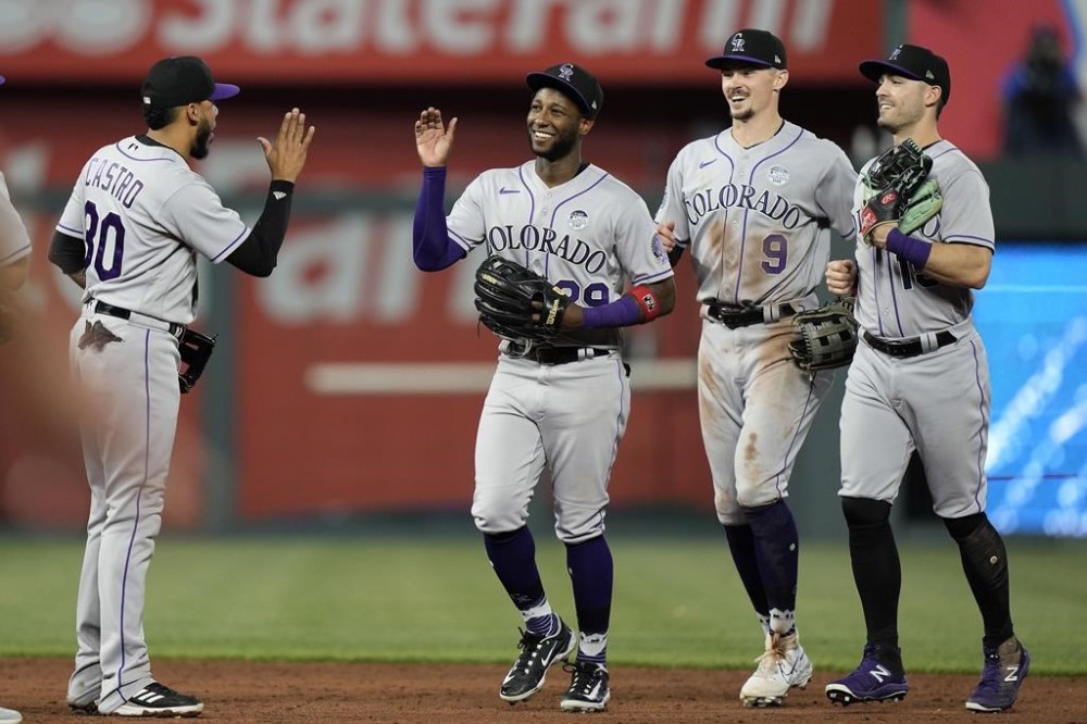 Colorado Rockies players celebrate after their baseball game against the Kansas City Royals Friday, June 2, 2023, in Kansas City, Mo. The Rockies won 7-2. (AP Photo/Charlie Riedel)