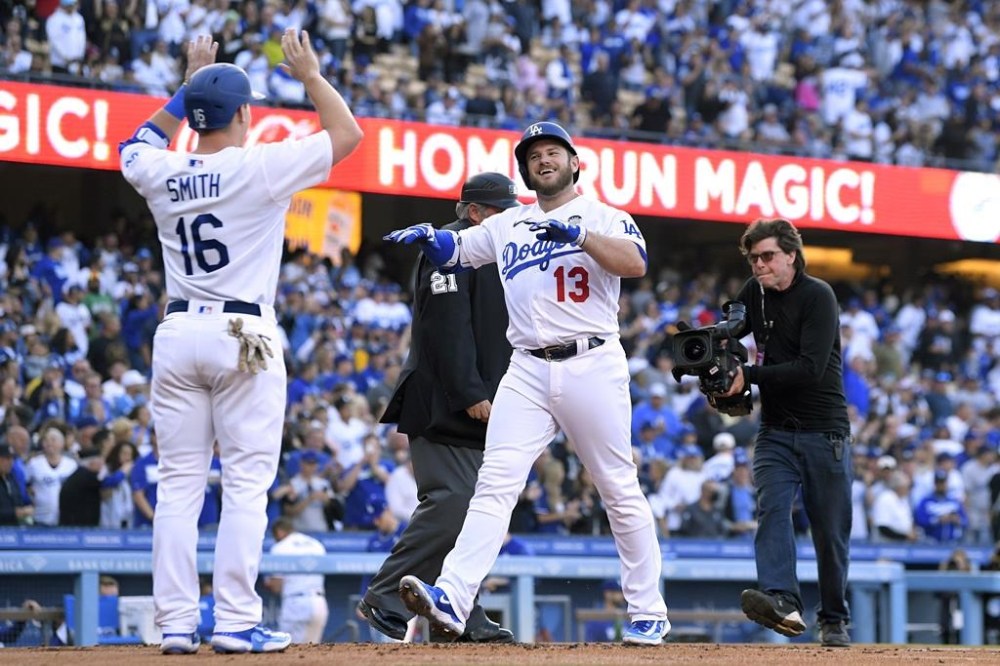 Los Angeles Dodgers' Max Muncy, right, is congratulated by Will Smith after hitting a two-run home run during the first inning of a baseball game Friday, June 2, 2023, in Los Angeles. (AP Photo/Mark J. Terrill)