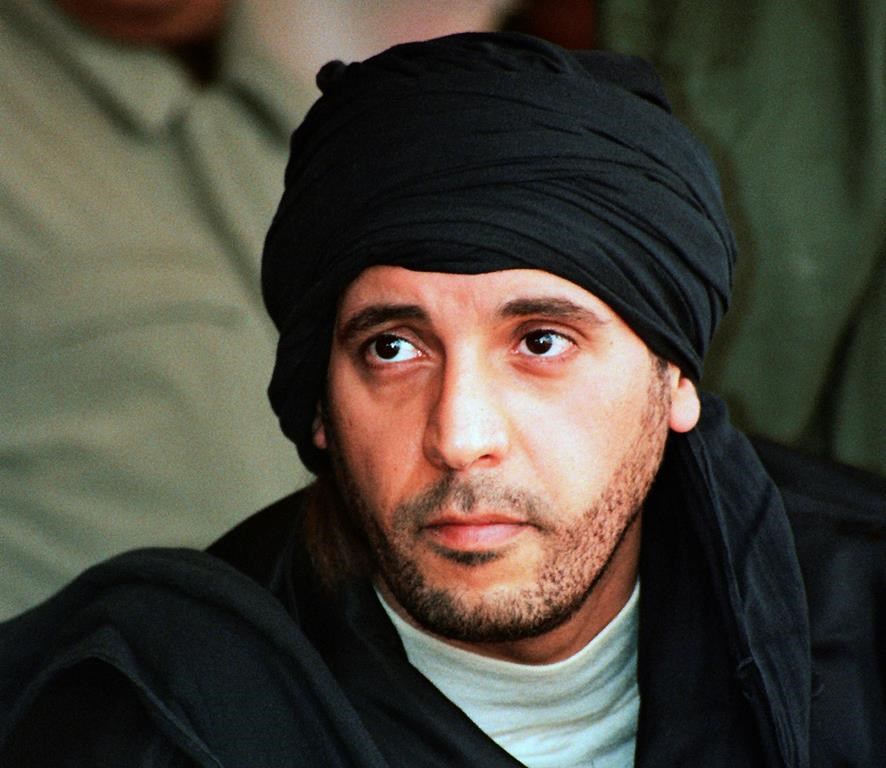 FILE - Hannibal Gadhafi, son of ousted Libyan leader Moammar Gadhafi, watches an elite military unit exercise in Zlitan, Libya, Sept. 25, 2011. Hannibal Gadhafi who has been held in Lebanon for more than seven years began a hunger strike Saturday, June 3, 2023, to protest his detention without trial, his lawyer said. (AP Photo/Abdel Magid al-Fergany, File)