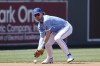Kansas City Royals shortstop Bobby Witt Jr. drops the ball after fielding a ground ball by Colorado Rockies batter Jurickson Profar during the first inning of a baseball game in Kansas City, Mo., Saturday, June 3, 2023. Profar was safe at first base and Witt was charged with an error on the play. (AP Photo/Colin E. Braley)