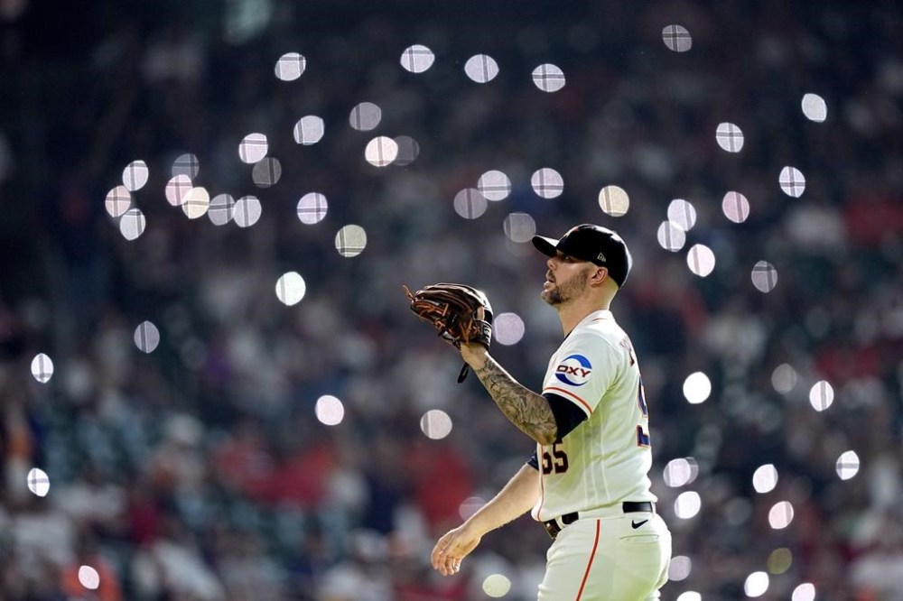 Houston Astros relief pitcher Ryan Pressly reaches for the ball as he takes the mound to pitch during the ninth inning of a baseball game against the Los Angeles Angels Saturday, June 3, 2023, in Houston. The Astros won 9-6. (AP Photo/David J. Phillip)