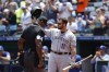 Colorado Rockies' Mike Moustakas gets a standing ovation from fans of his former team during the first inning of a baseball game against the Kansas City Royals in Kansas City, Mo., Sunday, June 4, 2023. (AP Photo/Colin E. Braley)