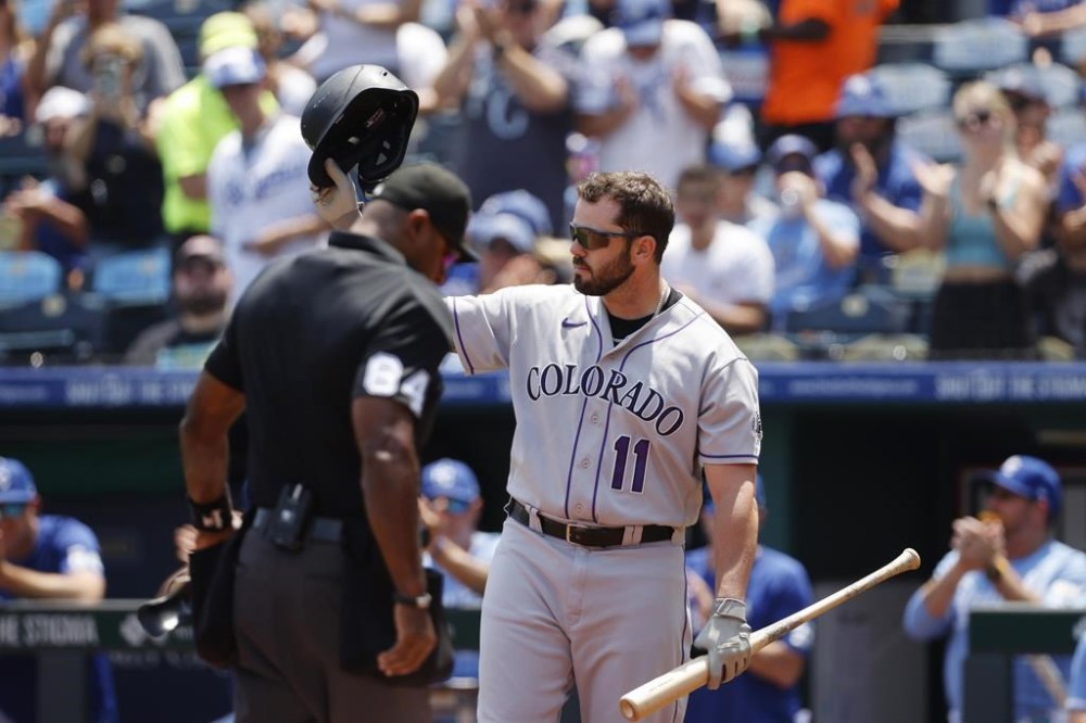 Colorado Rockies' Mike Moustakas gets a standing ovation from fans of his former team during the first inning of a baseball game against the Kansas City Royals in Kansas City, Mo., Sunday, June 4, 2023. (AP Photo/Colin E. Braley)