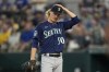 Seattle Mariners starting pitcher Bryce Miller adjust his cap as he stands on the mound while waiting to be pulled in the third inning of a baseball game against the Texas Rangers, Sunday, June 4, 2023, in Arlington, Texas. (AP Photo/Tony Gutierrez)